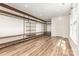 Large walk-in closet with custom wood shelving and industrial pipe supports, with wood-look floors at 3710 Cheleys Ridge Ln, Charlotte, NC 28270