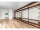 Spacious walk-in closet with custom wood shelving and industrial pipe supports, and wood-look floors at 3710 Cheleys Ridge Ln, Charlotte, NC 28270