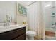 Bright bathroom featuring a shower-tub combo, patterned curtain, single sink, and decorative accents at 4093 Perth Rd, Fort Mill, SC 29707