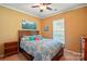 Bedroom with a decorative patterned bedspread, ceiling fan, and natural light from the window at 4093 Perth Rd, Fort Mill, SC 29707
