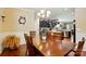 Open dining area with hardwood floors, chandelier, and view of the kitchen at 4093 Perth Rd, Fort Mill, SC 29707