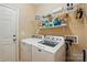 Functional laundry room featuring modern washer and dryer appliances, shelving, and ample storage at 4093 Perth Rd, Fort Mill, SC 29707