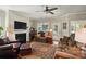 Comfortable living room with fireplace, plush seating, ceiling fan, and access to the outdoors at 4093 Perth Rd, Fort Mill, SC 29707