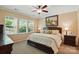 Relaxing primary bedroom with a large bed, bedside tables, and natural light from multiple windows at 4093 Perth Rd, Fort Mill, SC 29707