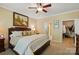 Primary bedroom featuring a large bed, ceiling fan, and access to the en suite and walk-in closet at 4093 Perth Rd, Fort Mill, SC 29707