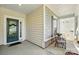 Cozy covered porch features seating and an inviting entry door at 4093 Perth Rd, Fort Mill, SC 29707
