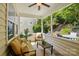 Relaxing screened porch featuring comfortable seating, a ceiling fan, and a view of the landscaped backyard at 4093 Perth Rd, Fort Mill, SC 29707