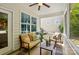Comfortable screened porch featuring a loveseat, chair, table, ceiling fan, and views of the yard at 4093 Perth Rd, Fort Mill, SC 29707