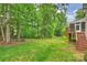 Expansive backyard featuring lush green grass, mature trees, and a relaxing outdoor area at 427 Pinnacle Ln, Huntersville, NC 28078