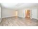 Spacious room with french doors featuring a window and new laminate flooring at 427 Pinnacle Ln, Huntersville, NC 28078