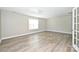Spacious bedroom featuring a window and new laminate flooring at 427 Pinnacle Ln, Huntersville, NC 28078