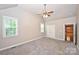 Spacious bedroom with plush carpet, neutral paint, and natural light from large windows at 427 Pinnacle Ln, Huntersville, NC 28078