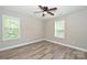 Bedroom featuring two windows, laminate flooring, and ceiling fan at 427 Pinnacle Ln, Huntersville, NC 28078