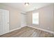 Bedroom featuring a window, new laminate flooring, and a built in closet at 427 Pinnacle Ln, Huntersville, NC 28078