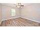 Bedroom featuring a window, laminate flooring, and a ceiling fan at 427 Pinnacle Ln, Huntersville, NC 28078