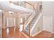 Welcoming foyer featuring a staircase, hardwood floors, and natural light from a large window at 427 Pinnacle Ln, Huntersville, NC 28078