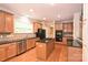 Kitchen area with wood cabinetry, stainless steel appliances, and a central island at 427 Pinnacle Ln, Huntersville, NC 28078