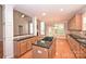 Open kitchen layout with granite countertops, center island cooktop, hardwood floors, and natural light at 427 Pinnacle Ln, Huntersville, NC 28078