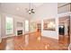 Open-concept living space with hardwood floors, fireplace, and adjoining kitchen area at 427 Pinnacle Ln, Huntersville, NC 28078