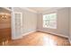 Office with hardwood flooring, wainscoting, and a large window providing natural light at 427 Pinnacle Ln, Huntersville, NC 28078
