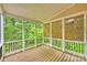 Relaxing screened porch featuring wood floors, white trim, and peaceful nature views with bamboo shades at 427 Pinnacle Ln, Huntersville, NC 28078