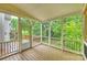 Beautiful screened porch with wood flooring, white trim, and views of lush greenery at 427 Pinnacle Ln, Huntersville, NC 28078