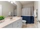 Well-lit bathroom with single vanity, shower, and neutral finishes at 440 S Sharon Amity Rd, Charlotte, NC 28211
