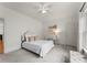 Bright, minimalist bedroom with white walls, plush carpet, and modern furniture at 440 S Sharon Amity Rd, Charlotte, NC 28211
