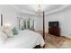 Bright bedroom features a four poster bed, elegant chandelier, and a cozy bay window seating area at 440 S Sharon Amity Rd, Charlotte, NC 28211