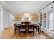 Elegant dining room featuring hardwood floors, decorative wallpaper, and large windows for abundant light at 440 S Sharon Amity Rd, Charlotte, NC 28211