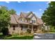 Inviting two-story brick home with manicured lawn, mature trees, and traditional architectural details at 440 S Sharon Amity Rd, Charlotte, NC 28211