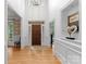 Inviting foyer with hardwood floors, high ceilings, and elegant chandelier, providing a grand entrance at 440 S Sharon Amity Rd, Charlotte, NC 28211