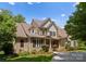 Beautiful two-story brick home with a manicured lawn and inviting front porch, showing curb appeal at 440 S Sharon Amity Rd, Charlotte, NC 28211
