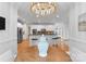 Open-concept kitchen with island seating, modern appliances, and stylish pendant lighting fixture at 440 S Sharon Amity Rd, Charlotte, NC 28211