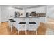 Large kitchen island with granite countertops, seating for four, and modern cabinetry at 440 S Sharon Amity Rd, Charlotte, NC 28211