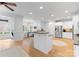 Spacious kitchen featuring a large island with seating, stainless steel appliances, and hardwood flooring at 440 S Sharon Amity Rd, Charlotte, NC 28211