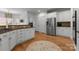 Spacious kitchen with white cabinetry, stainless steel appliances, and beautiful granite countertops at 440 S Sharon Amity Rd, Charlotte, NC 28211
