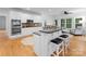 Gourmet kitchen features a large island, double ovens, stainless steel appliances, and breakfast nook at 440 S Sharon Amity Rd, Charlotte, NC 28211