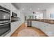 Bright kitchen featuring stainless steel appliances, ample cabinet space, and hardwood flooring at 440 S Sharon Amity Rd, Charlotte, NC 28211