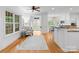 Bright and airy living room with hardwood floors, neutral decor, and cozy seating area near the windows at 440 S Sharon Amity Rd, Charlotte, NC 28211