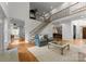 Expansive living room showcasing staircase, hardwood floors, ample natural light, and open layout at 440 S Sharon Amity Rd, Charlotte, NC 28211