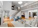 Open-concept living room with hardwood floors, staircase, and large windows, ideal for entertaining guests at 440 S Sharon Amity Rd, Charlotte, NC 28211