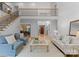 Bright living room with hardwood floors, staircase, and views into the dining room and foyer, perfect for gatherings at 440 S Sharon Amity Rd, Charlotte, NC 28211