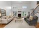 Spacious living room boasts a fireplace, large windows, neutral tones, and comfortable seating arrangement at 440 S Sharon Amity Rd, Charlotte, NC 28211