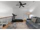 Bright loft area featuring a ceiling fan, comfortable seating, and an exercise machine at 440 S Sharon Amity Rd, Charlotte, NC 28211