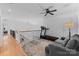 The loft features hardwood floors and a treadmill for a home workout space at 440 S Sharon Amity Rd, Charlotte, NC 28211