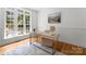 Bright home office with a large window, neutral decor, hardwood floors, and a tranquil atmosphere at 440 S Sharon Amity Rd, Charlotte, NC 28211