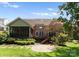 Home's rear boasts a screened porch, deck, stone patio, and manicured yard for outdoor enjoyment at 440 S Sharon Amity Rd, Charlotte, NC 28211