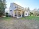 Spacious backyard featuring a covered patio and lush lawn at 5076 Timber Falls Dr, Indian Land, SC 29707