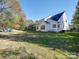 Large backyard view showcasing the home's exterior and green space at 5076 Timber Falls Dr, Indian Land, SC 29707